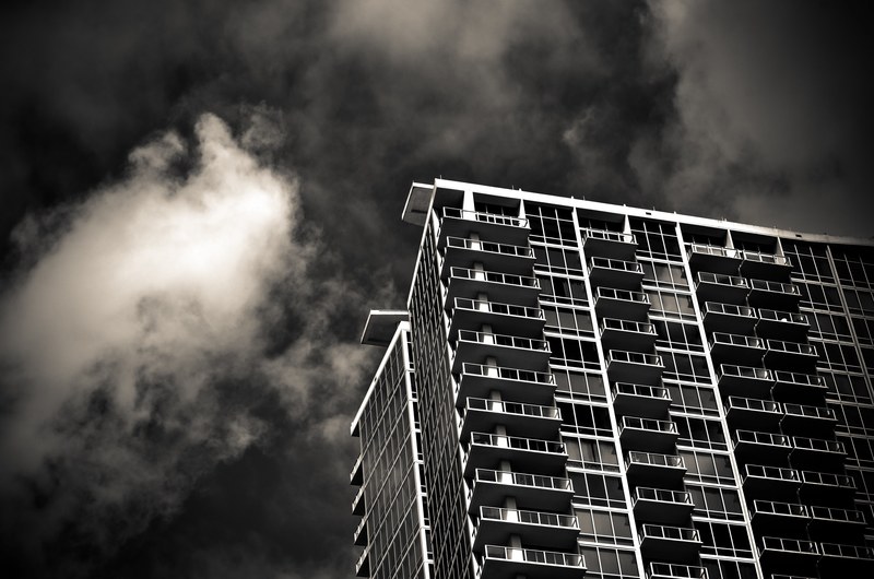 black and white shot of urban condo apartment building from below with clouds orlando, apartment in orlando 4k