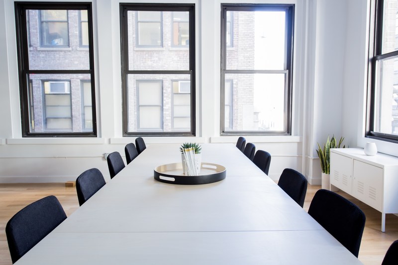 an empty conference room in an office with a table chairs and big windows, minimalist meeting room 4k