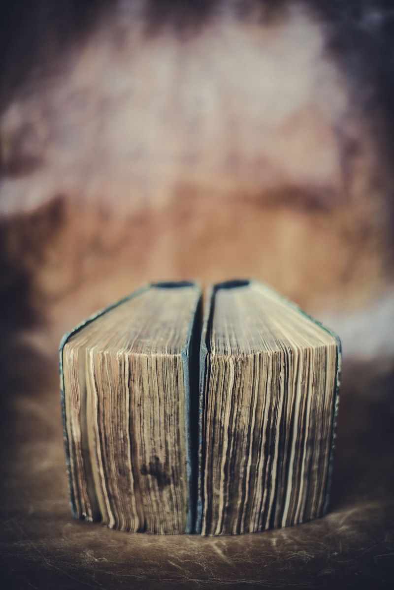 two vintage hardcover books with deteriorating pages laying next to each other, _books 4k