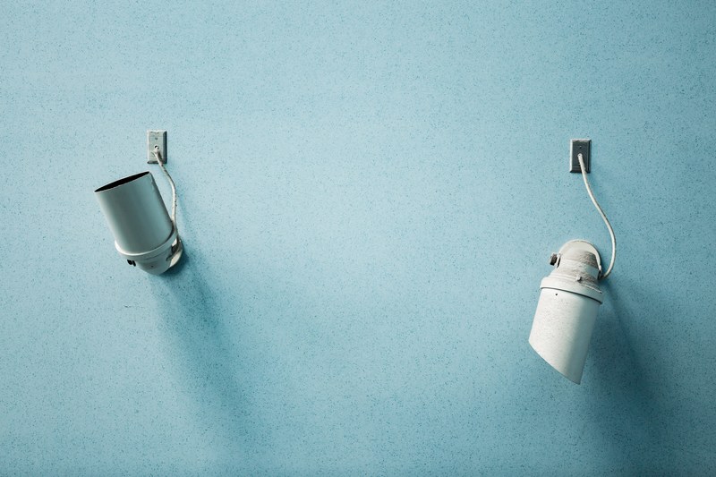 two studio lights pointing in opposite directions on a pastel blue plane, minimalism 4k