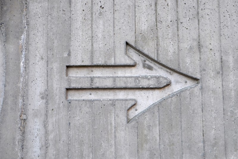 an arrow etched in a concrete wall, concrete arrow 4k