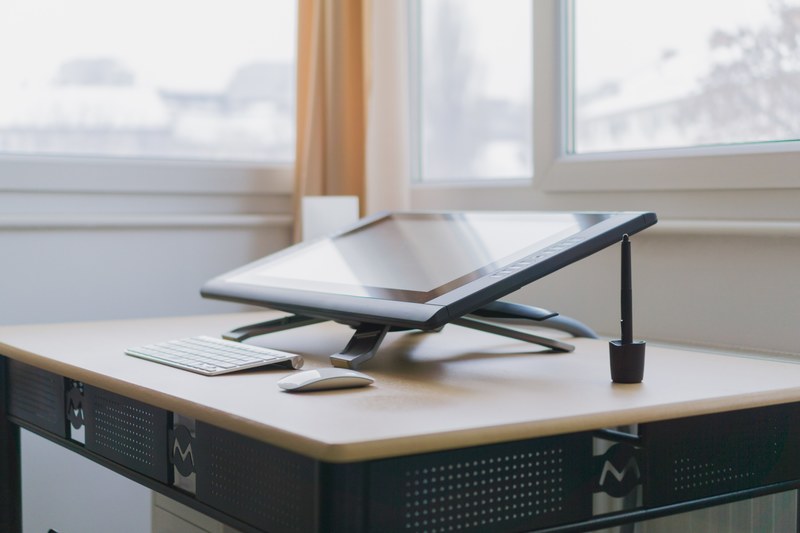a wacom drawing tablet on a desk in a corner of a room, wacom cintiq 22hd workspace 2 4k