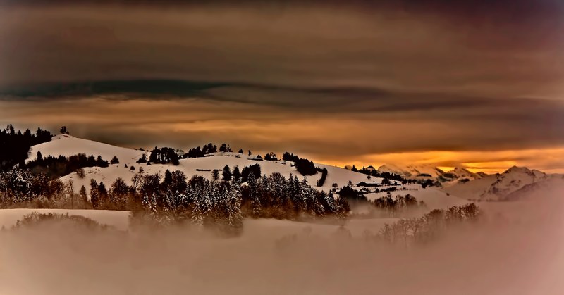 orange sky shines over a snowy hillscape in hirzel, hillscapes in hirzel 4k