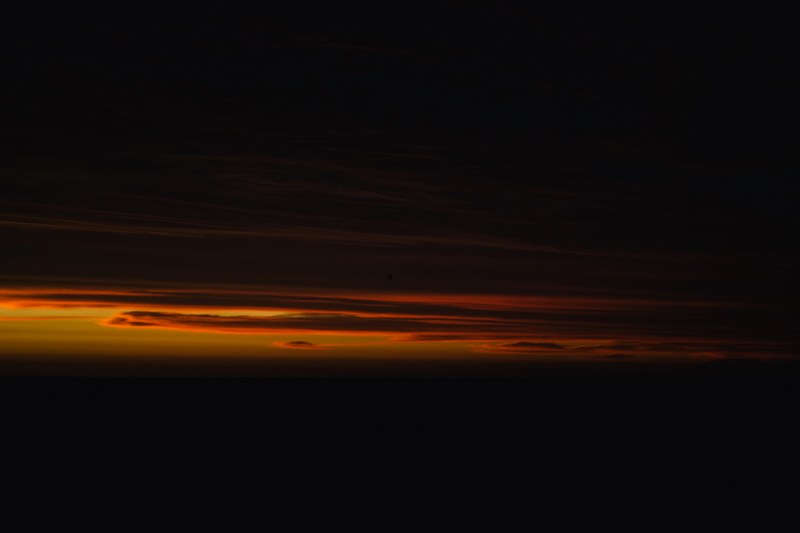 clouds let through a last bit of light during sunset before it is getting dark, colorful clouds on a dark sky 4k