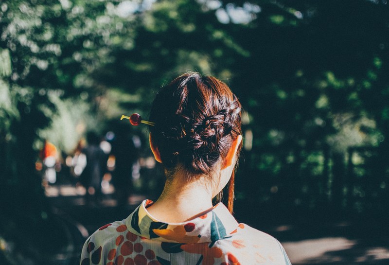 standing behind a woman with fashionable braided hair in the park, woman with braid 4k