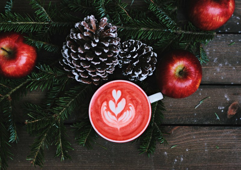 overhead shot of apples pinecones fir and a red coffee, cozy christmas coffee 4k