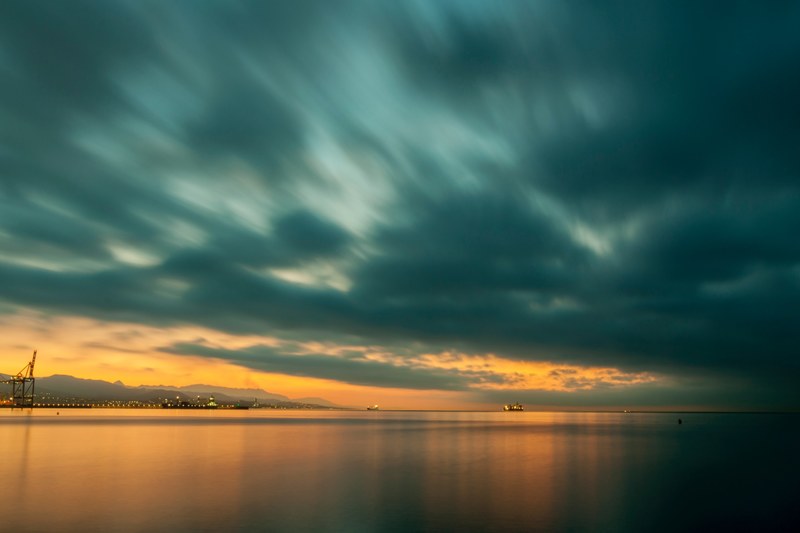 blue clouds swept across sky and water at playa de la misericordia, amanecer en la misericordia 4k