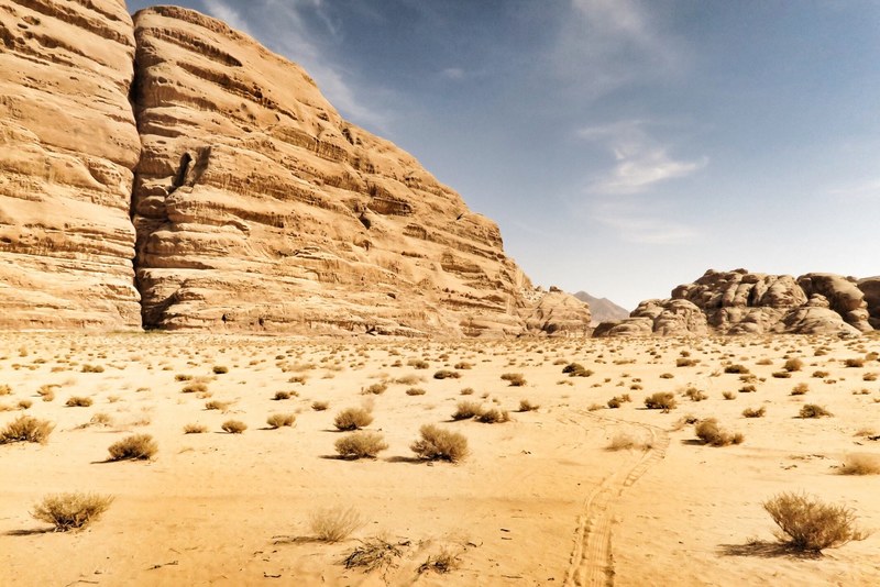 sandy mountains in the arid valley of wadi rum camping, sandstone and sun 4k
