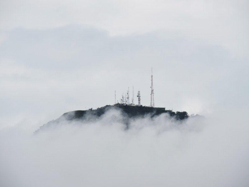 radio towers on top of a cloud shrouded mountain in brazil, mountaintop radio towers 4k