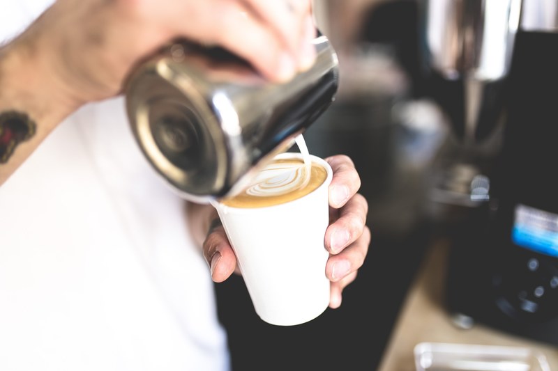a barista pouring milk into a coffee cup, barista pouring milk 4k