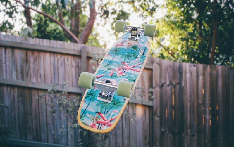 a colorful skateboard suspended in the air upside down, colorful skateboard 4k