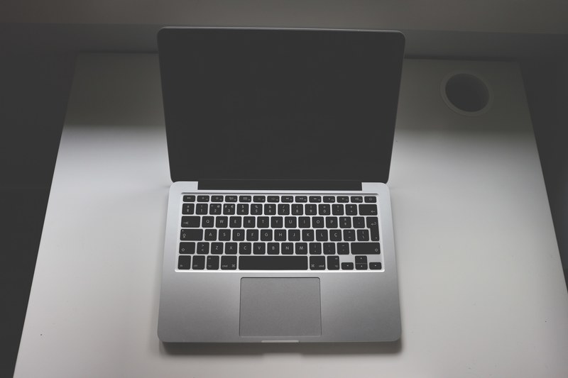 an overhead shot of an open macbook on a white table, an open mac 4k