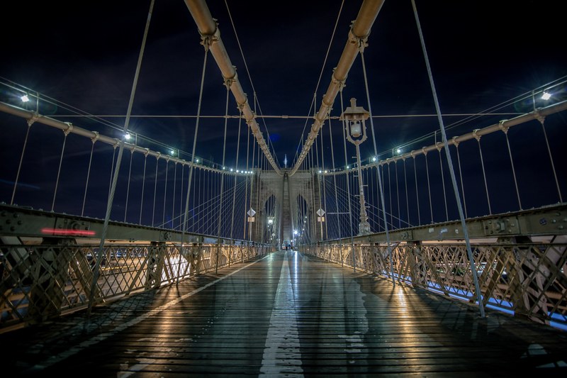 the walkway of the brooklyn bridge in new york city at night, midnight stroll 4k