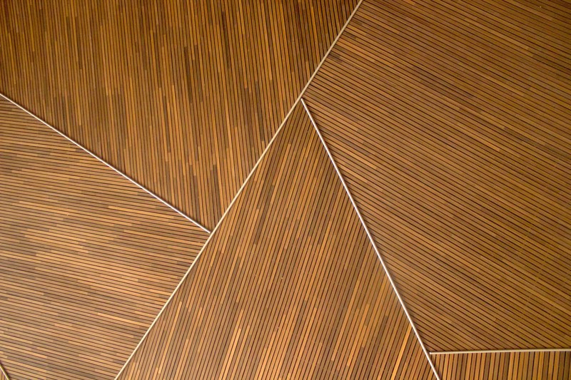 a triangle shaped wooden background texture pattern at the shanghai performing arts center, geometric wood pattern 4k