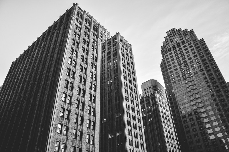 a black and white shot of skyscrapers in the downtown, skyscrapers from below 4k