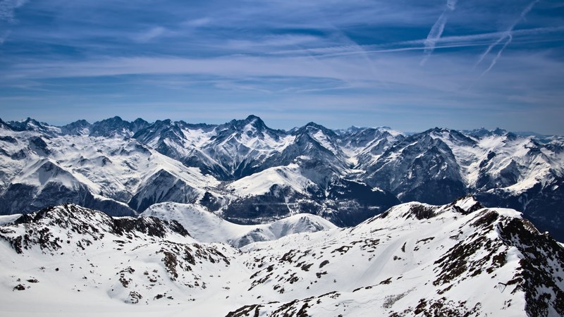 sharp snow covered mountain peaks stretching to the horizon, white highland 4k