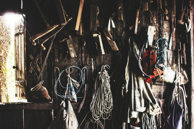 various tools and ropes hanging from a wall in a workshop, tools on a workshop wall 4k