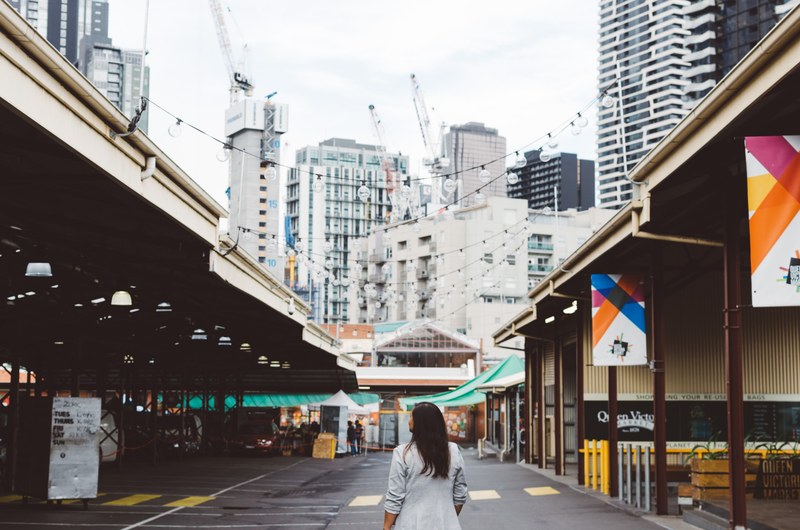 a woman walking on the street at the queen victoria market in melbourne australia, queen victoria market walk 4k