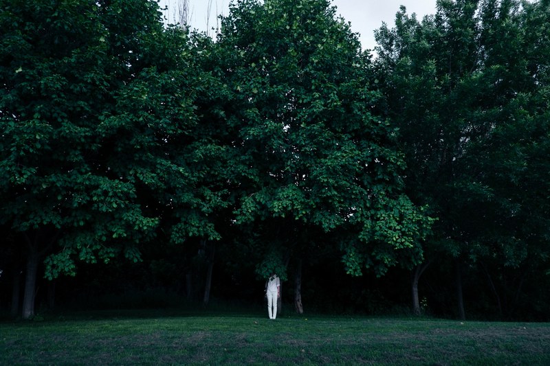 a person dressed in all white standing underneath a tree, _under a tree 4k
