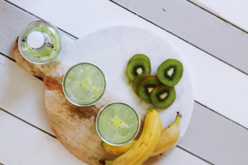 the top view of a bottle two glass cups and fruits on a plate in london, bottle glass cups and fruits 4k