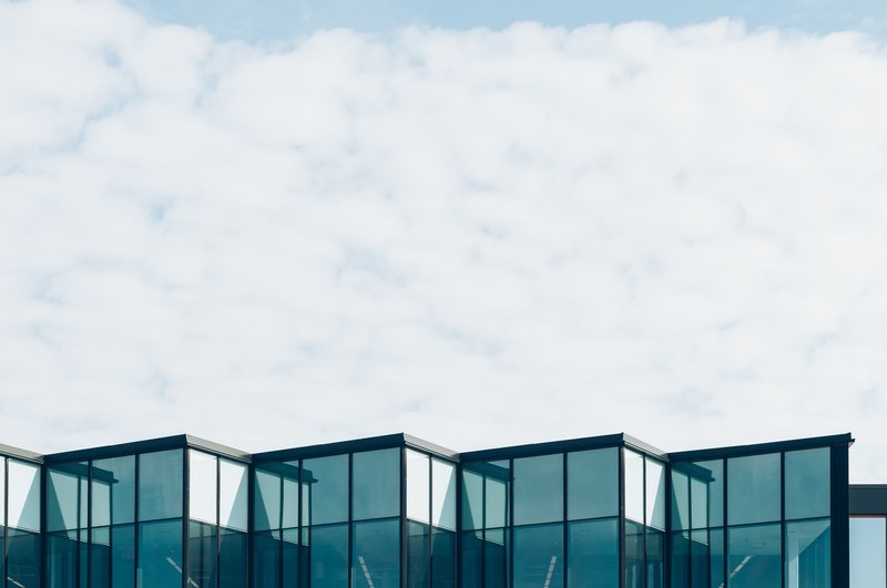 the top part of a building with glass to ceiling windows, glass cube architecture 4k