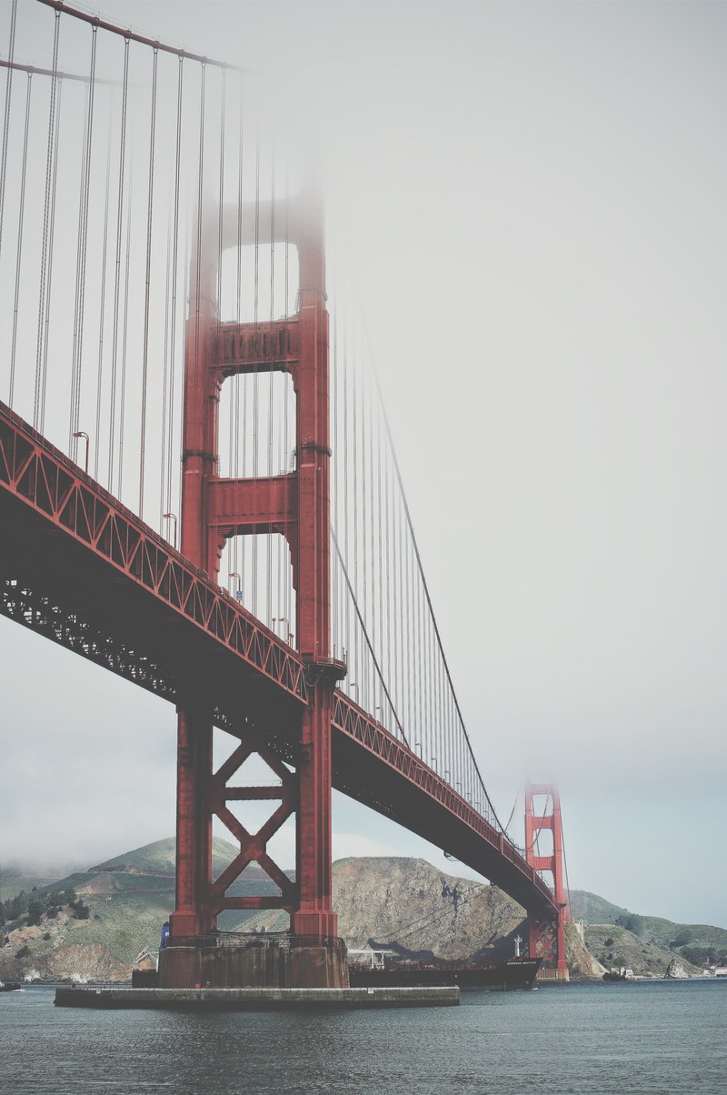 golden gate bridge disappears into the clouds by the bay, fog over the bay 4k