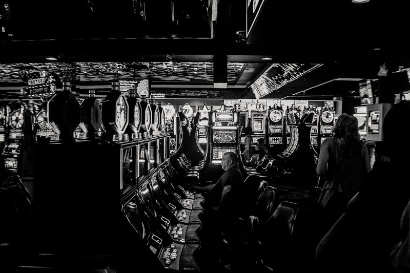 people sitting inside a las vegas strip casino playing the slot machines, vegas lights 4k