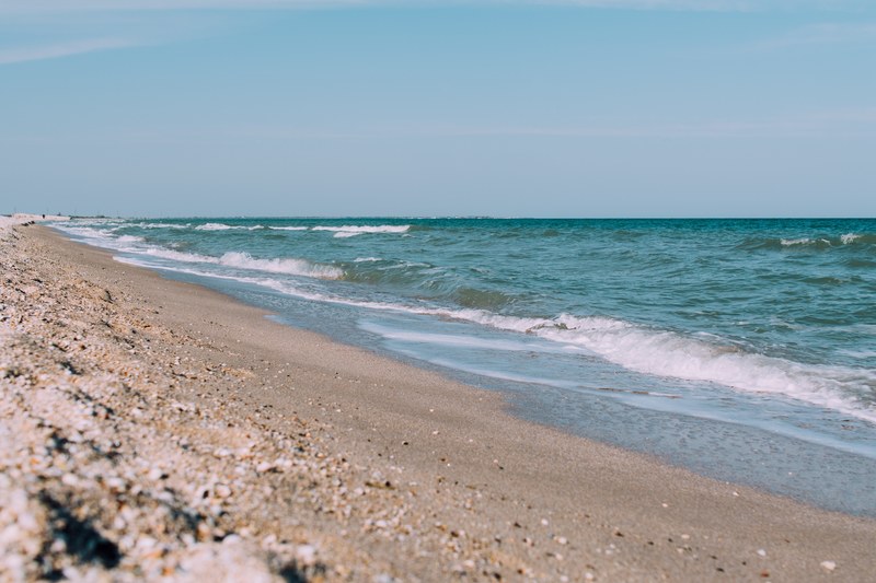ocean washing on a sandy shore at kyrylivka, ocean washing ashore 4k