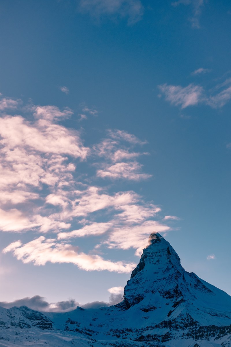 the matterhorns snowy peak reaches up to touch clouds in the sky, matterhorn touches clouds 4k
