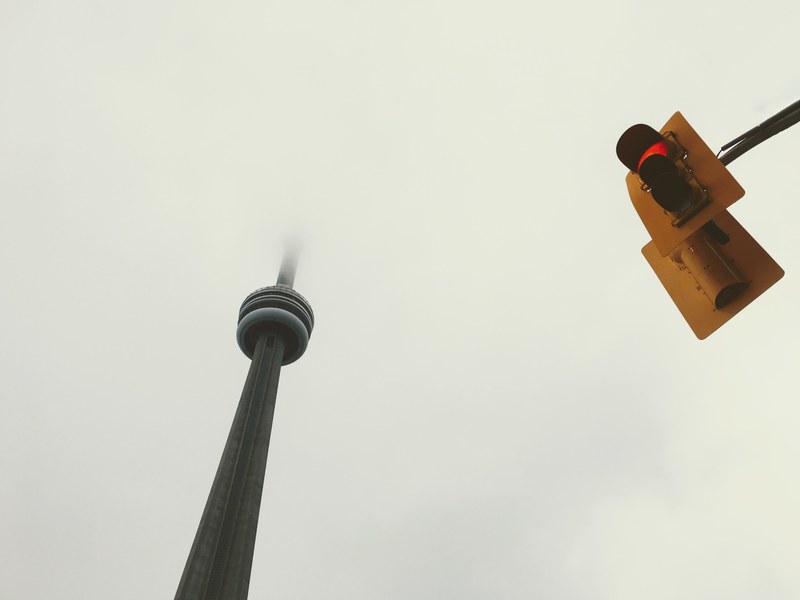 tourist shot of cn tower in toronto at the entertainment district, foggy day 4k