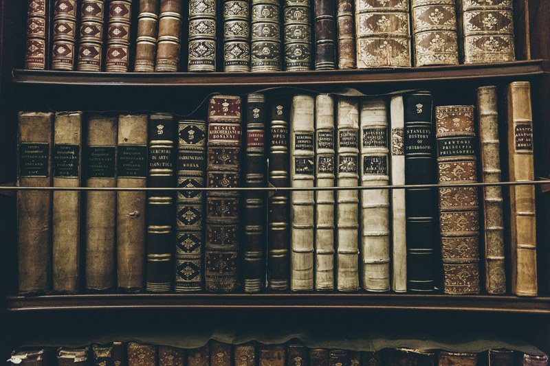 a vast collection of older books in the library spines facing out full of history and antiques, _collection of old books 4k
