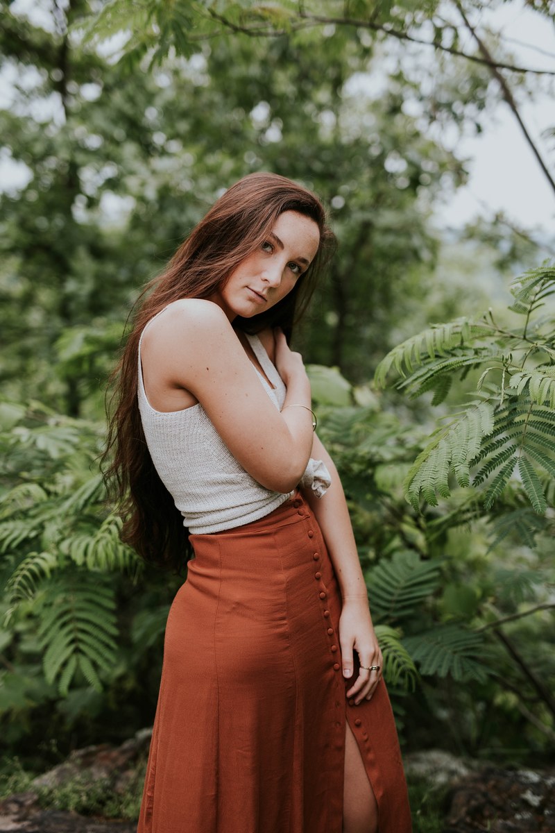 woman modeling a skirt outside by ferns, skirt model 4k