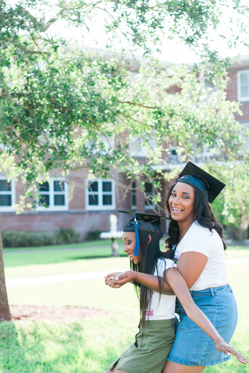 female african american friends posing happily for a photo on high school graduation day, _high school graduation friends 4k