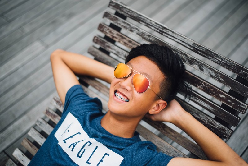 a happy asian male sitting on a wooden chair, _happy asian male 4k