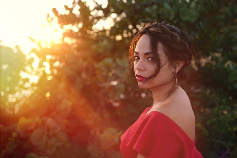 woman in a red dress looks over her shoulder at sunset, last look from florida 4k
