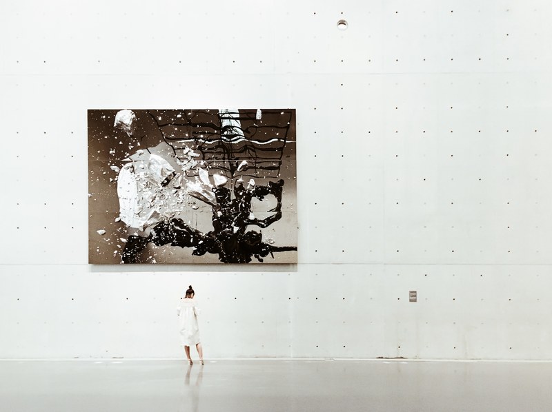 a woman standing near a painting in a modern art gallery, woman viewing abstract art 4k