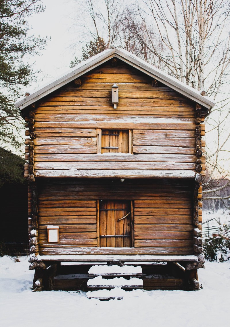 a small two storey log cabin with steps leading onto the front deck, two level wooden winter chalet 4k