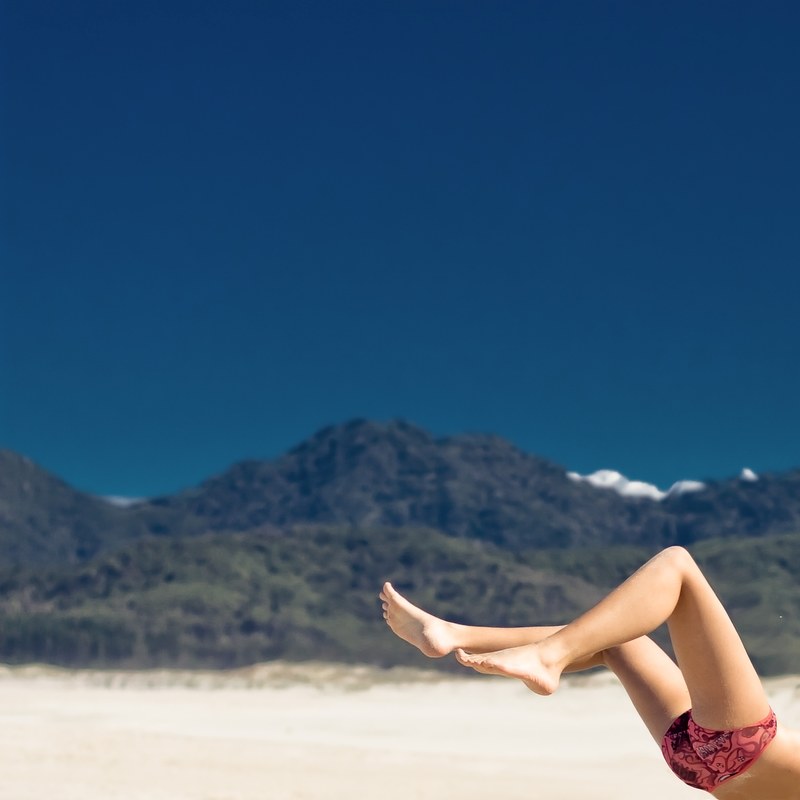 womans leg features in landscape view of a huge distant mountain in summer great barrier island, summer at great barrier island 4k