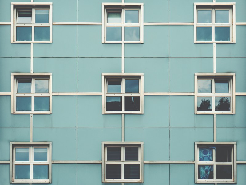 symmetrical square windows in the blue wall of a building in cologne, _square windows wall cologne 4k