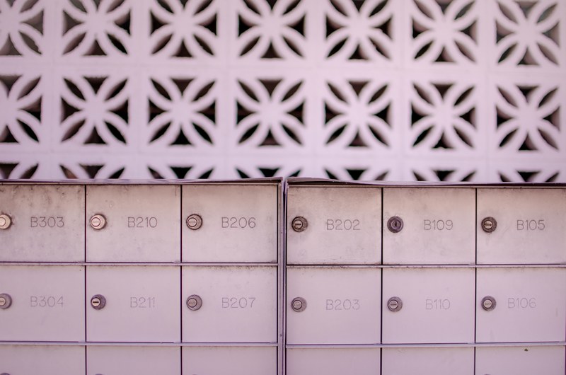 pink rows of mailboxes in front of pink cement architecture in ocean city, numbers and letters 4k