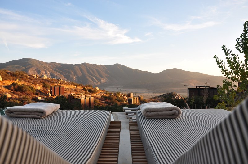 view from deck chairs with folded towels on top of them on a sunny mountain valley, deck chairs in the mountains 4k