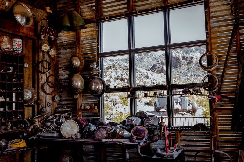 vintage junk shop interior in nelson and window with antique classic car outside, shop window part and junk 4k
