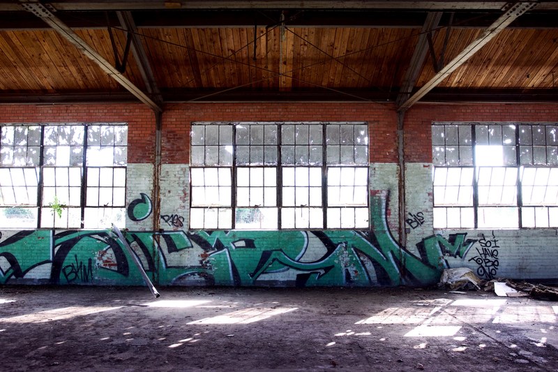 inside an empty old building with graffiti large windows and wooden rafters, _old empty building with graffiti 4k