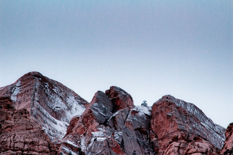 red rock formation covered in a thin layer of snow, winter in icebox canyon 4k