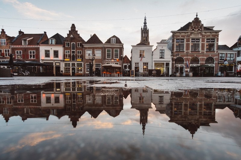 beautiful puddle reflection of a small artisan town in europe, _vintage city vibes 4k