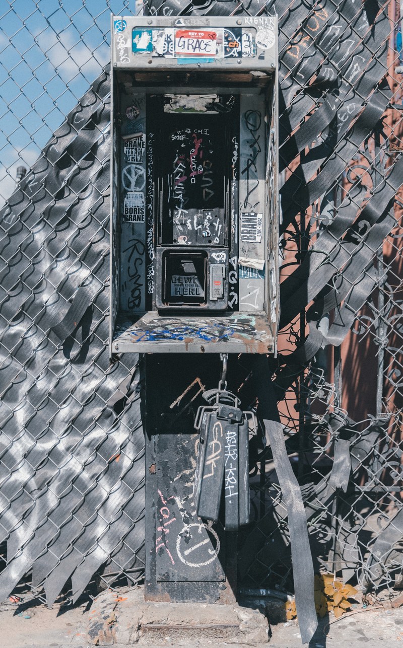 abandoned and damaged payphone phonebooth with covered in graffiti tags, payphone 4k