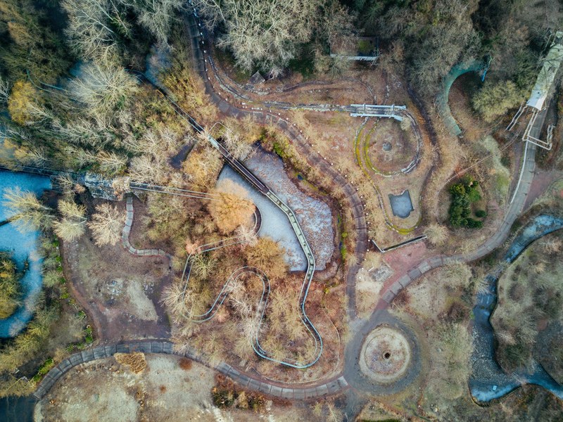 a drone shot of streams and dilapidated structures in a forest, spreepark berlin by my drone 4k