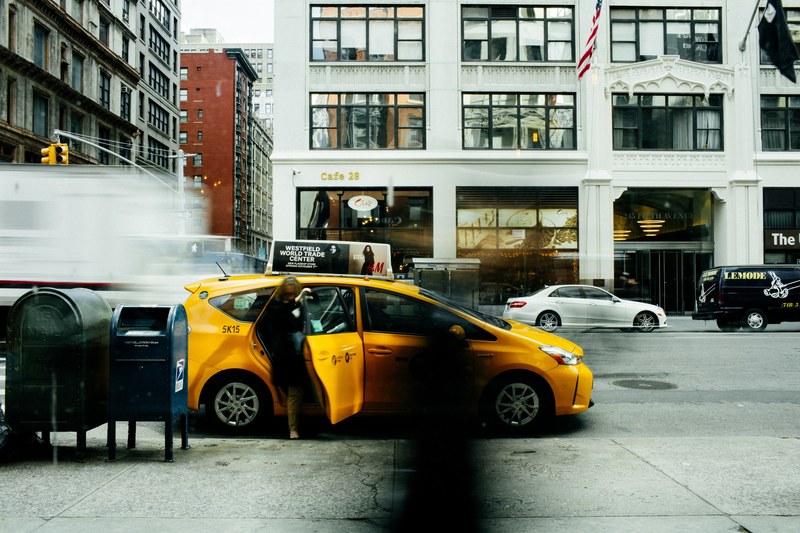 person gets into a taxicab on a busy city street in new york, catching a cab 4k