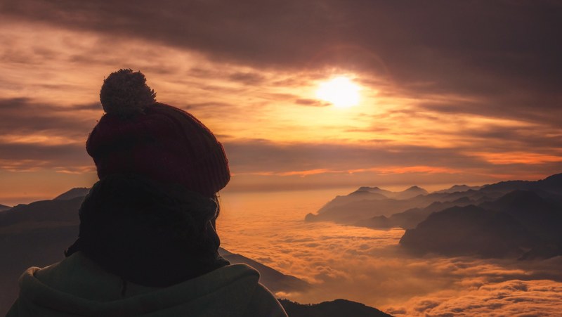the silhouette person sitting on monte stivo viewing the sunrise or sunset, silhouette person on monte stivo 4k