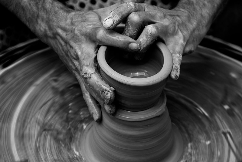 messy hands sculpting on a pottery wheel in motion, pottery wheel 4k